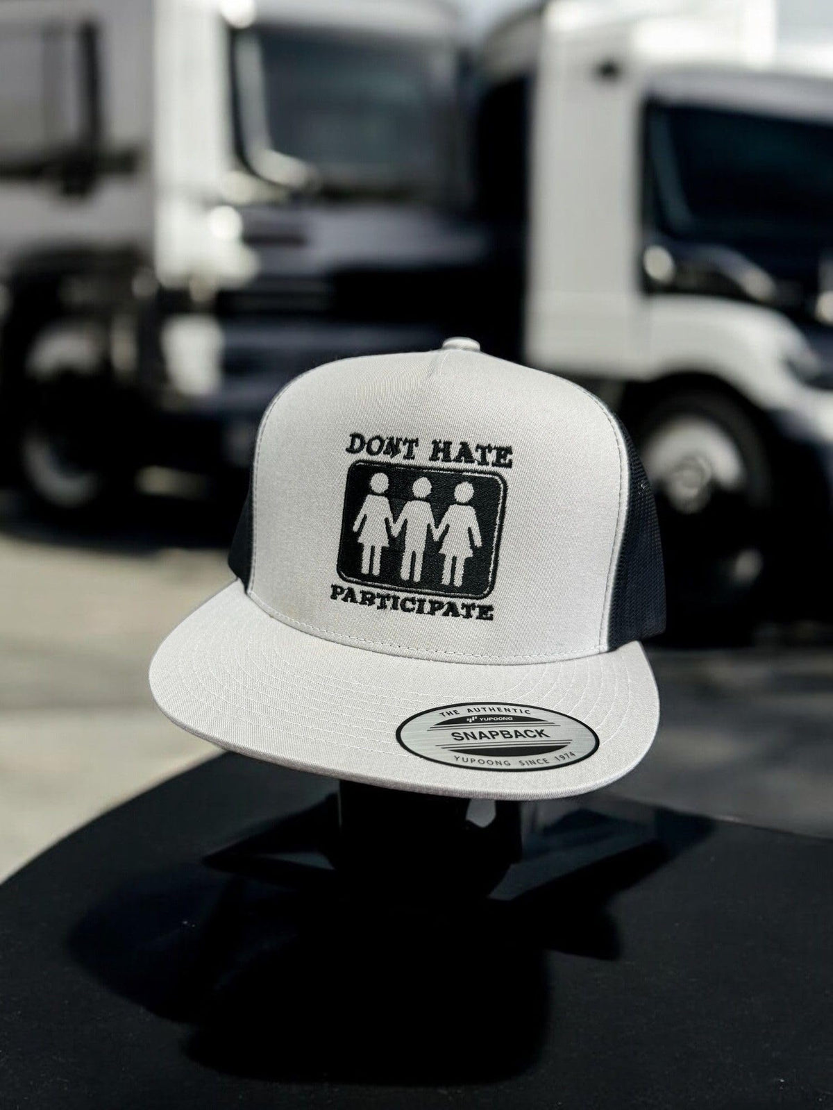 Don't Hate Participate — Don’t Hate Participate - Grey and Black - Flat Bill Embroidered Trucker Hat — existing lifestyle 1